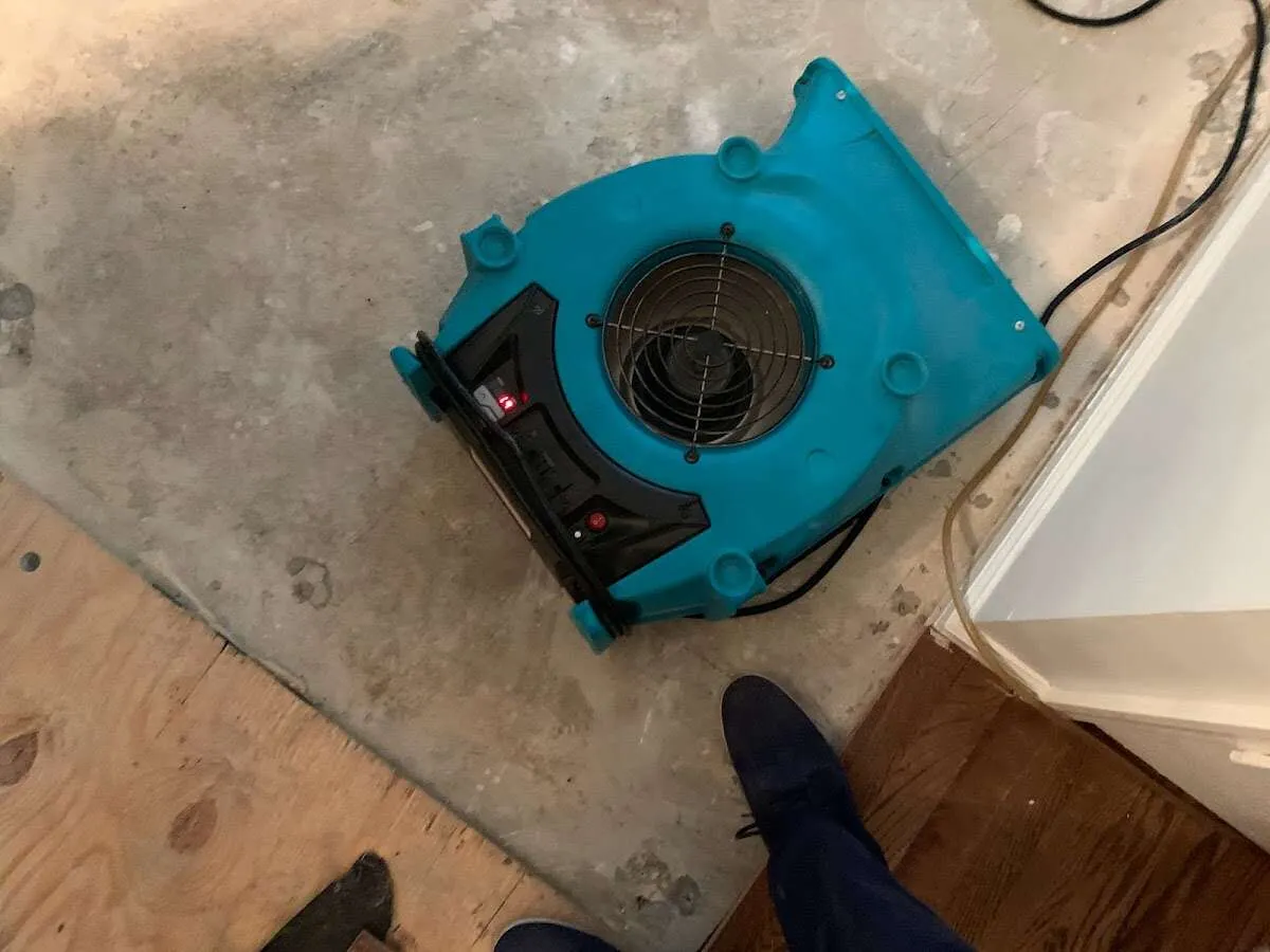 Air mover drying subfloor during Commercial Water Damage Restoration in Cathedral City